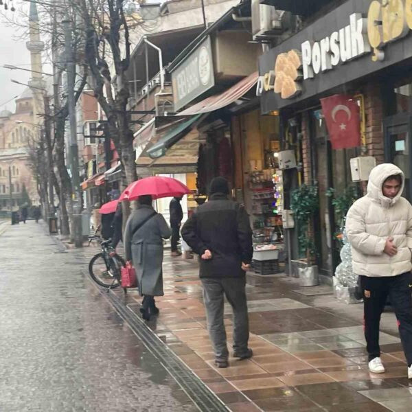 Eskişehir'de yağış nedeniyle vatandaşlar şemsiye ve şapka ile yağdan korunmaya çalışıyorlar.-3